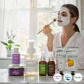 Woman applying facial mask with skincare products on a table