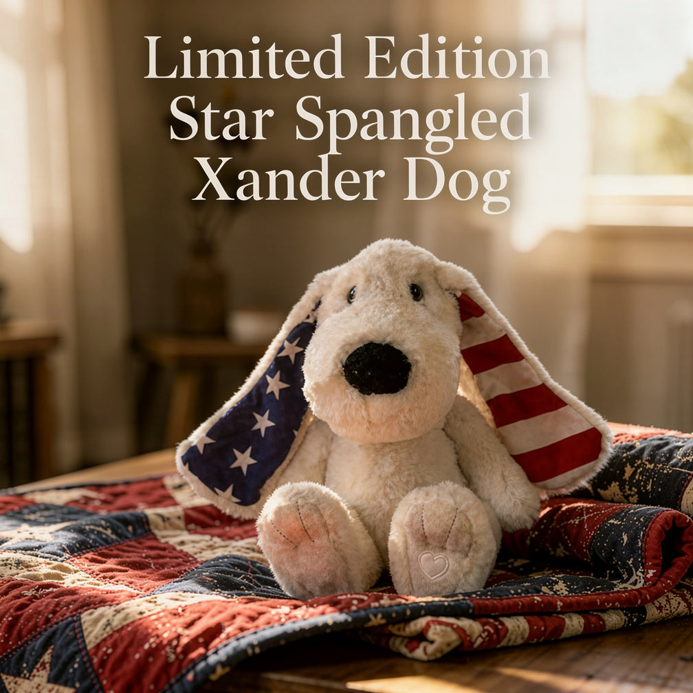 Stuffed dog toy with American flag design on a quilted blanket, text 'Limited Edition Star Spangled Xander Dog' above.